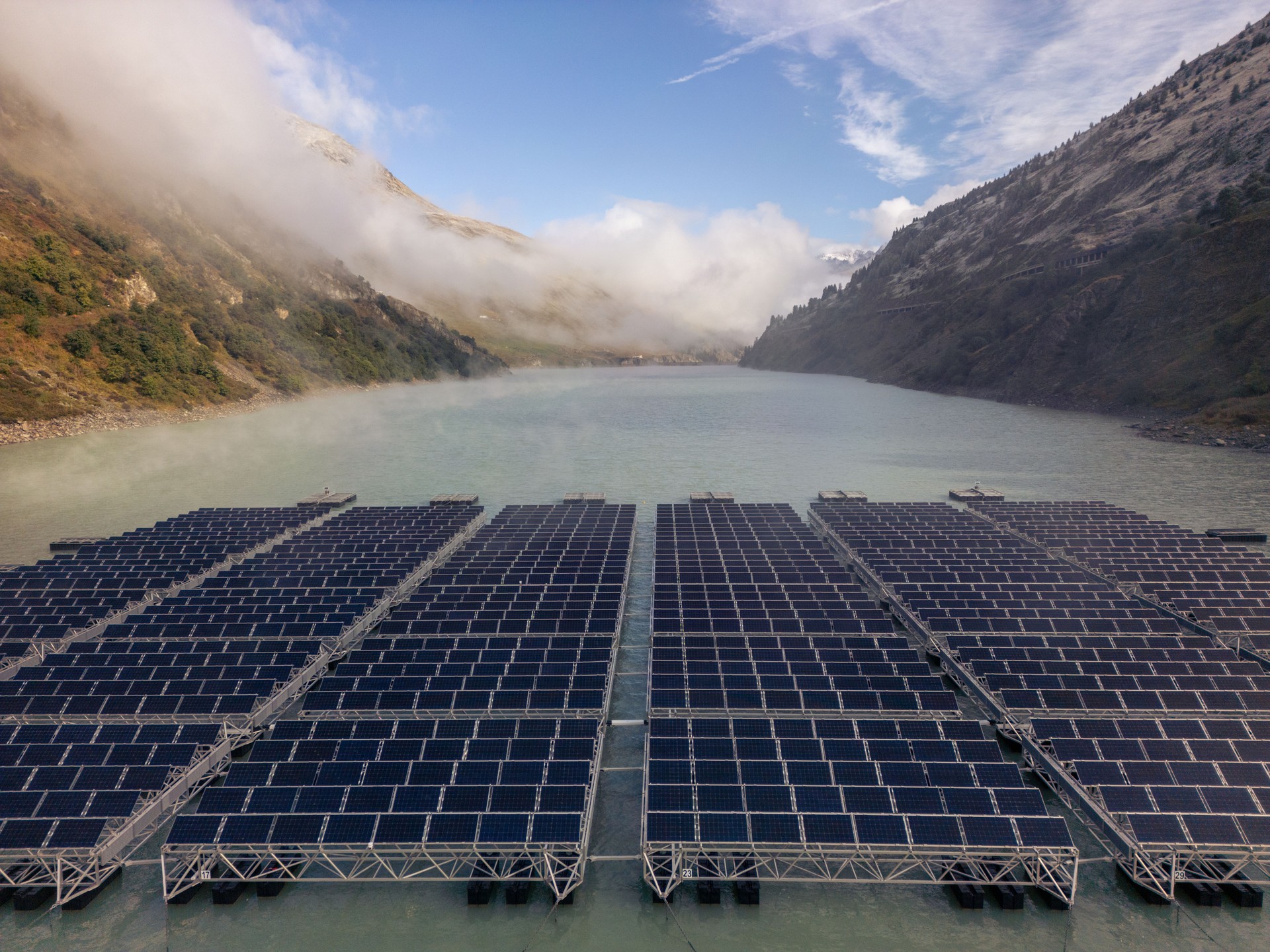 Floating Solar Panels with Foggy Mountainous Backdrop